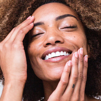 Woman applying lotion to face