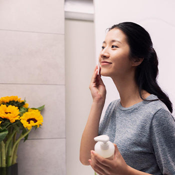 Woman cleansing her face