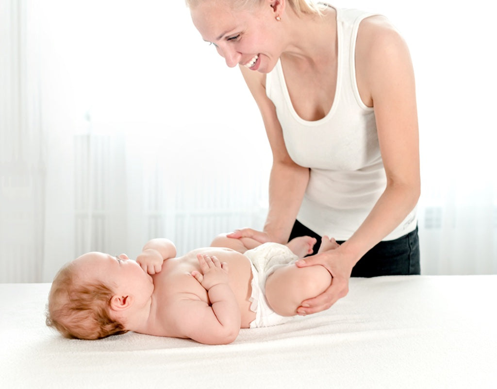 Mom doing a massage for constipation on baby