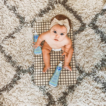 baby looking up from carpet