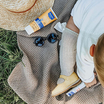 baby outside with Mustela mineral sunscreen