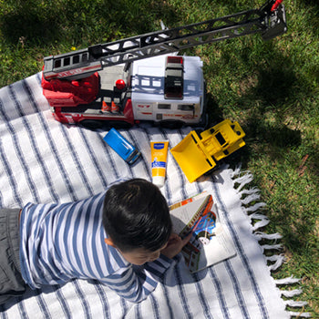 child playing outside with toys