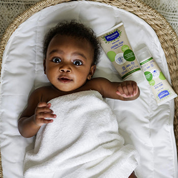 baby swaddled laying in a basket