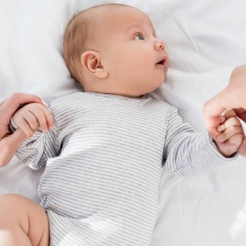 Baby looking up at parent during bonding time