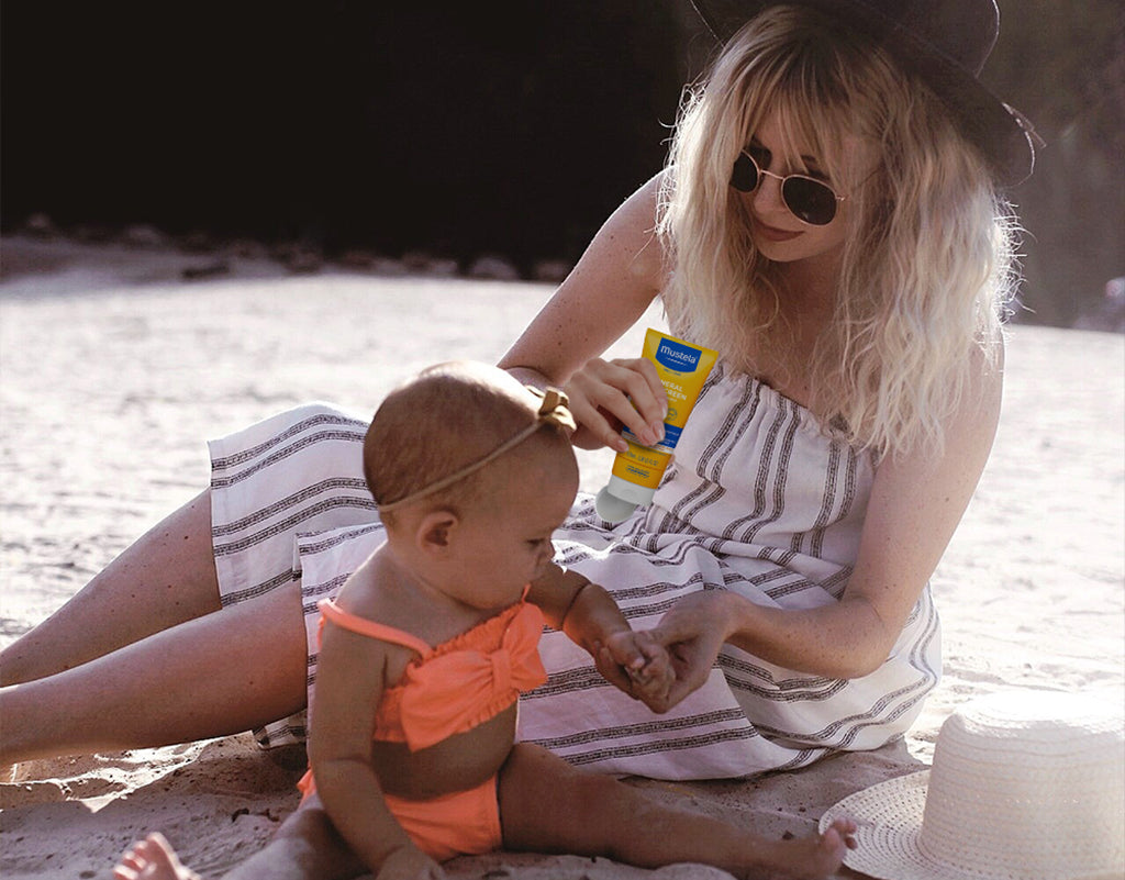 Mom applying non-nano zinc oxide sunscreen on child