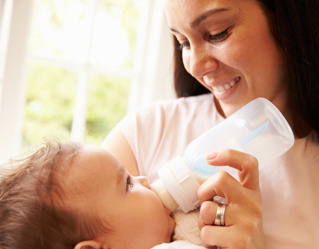 Mom feeding baby with natural baby products 
