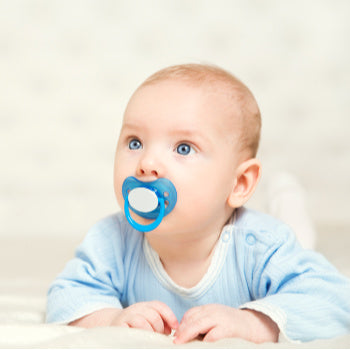 baby sucking on pacifier