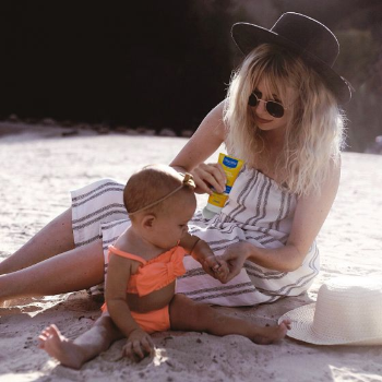 Mom applying sunscreen products that are free of parabens