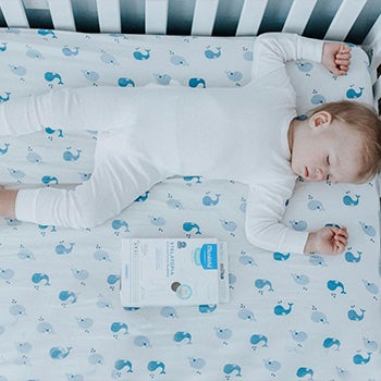 young child sleeping in crib