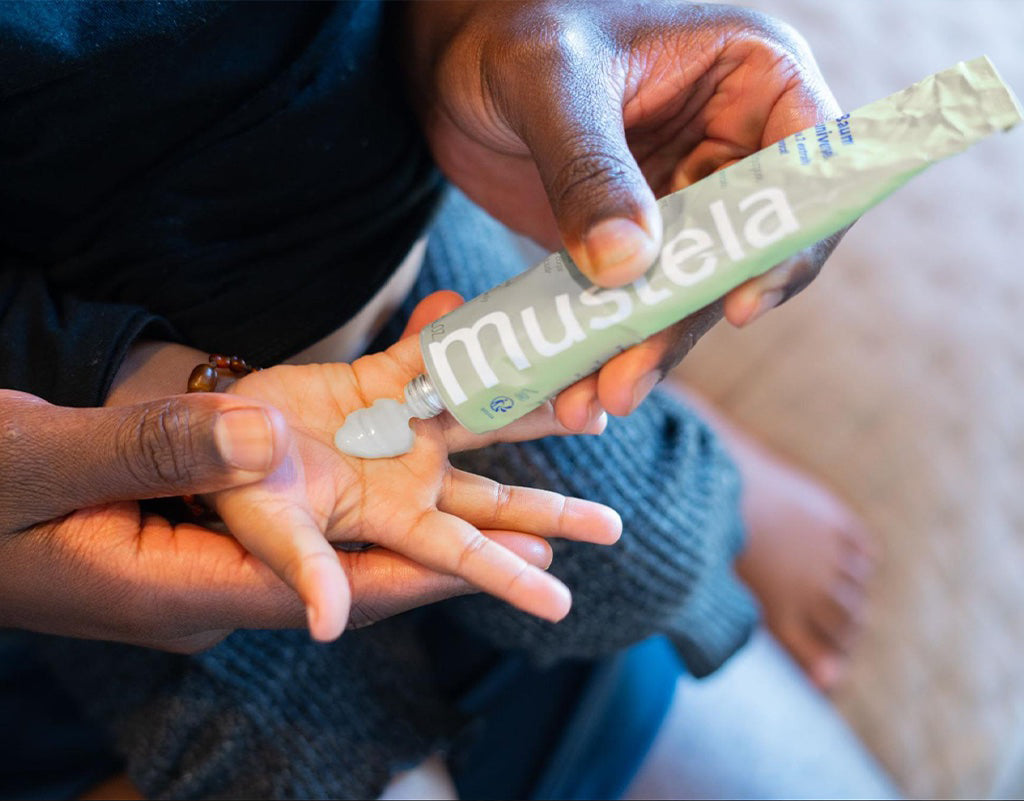Mustela hand cream being applied to kids hand