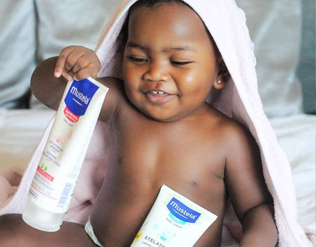 Little boy with Mustela Skin care products 