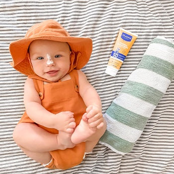 Baby next to sunscreen for eczema