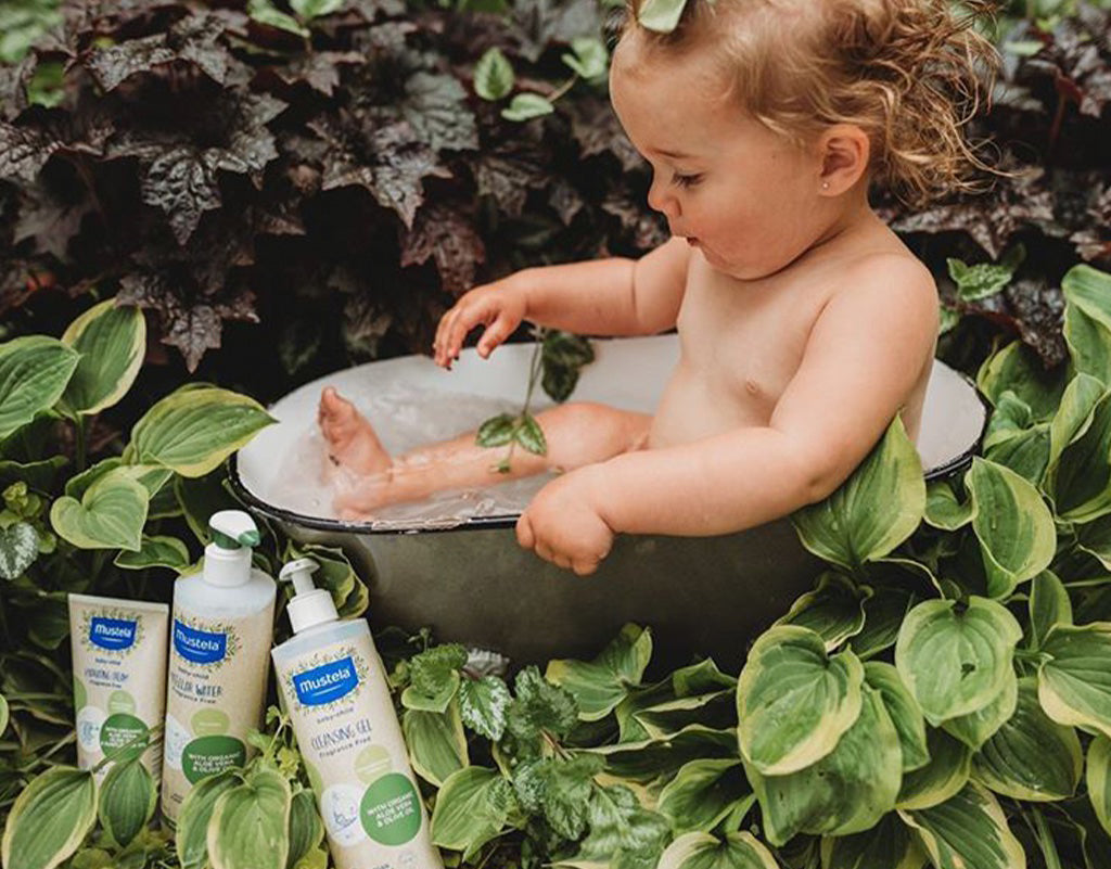 Baby taking a bath with sustainable baby products