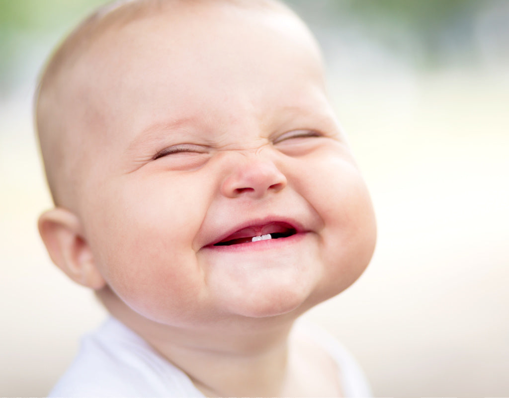 Smiling baby whose teething