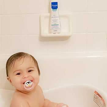 baby in crib sucking on a pacifier instead of thumb sucking