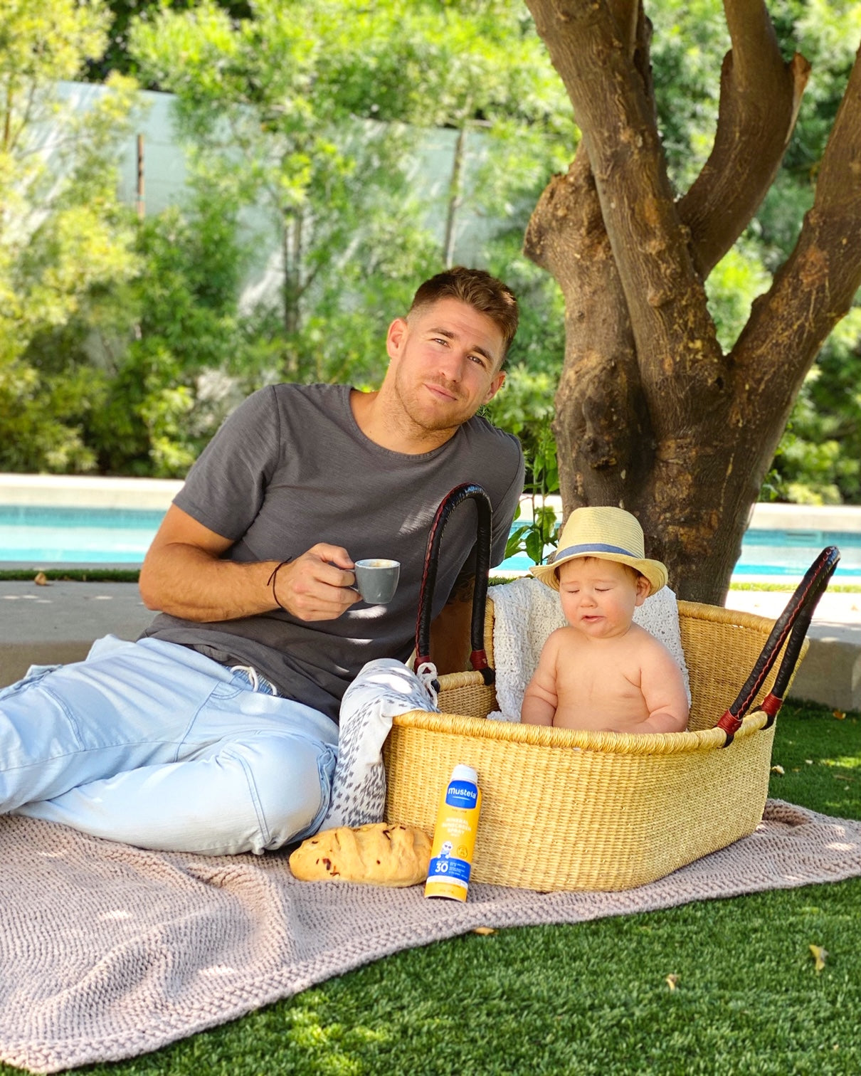 Dad having a picnic with baby wondering when do babies sit up