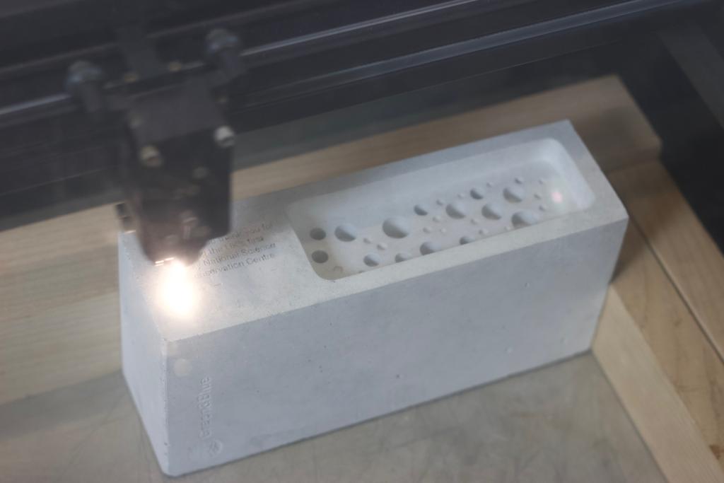 Green&Blue bee brick being etched at Cut By Beam 