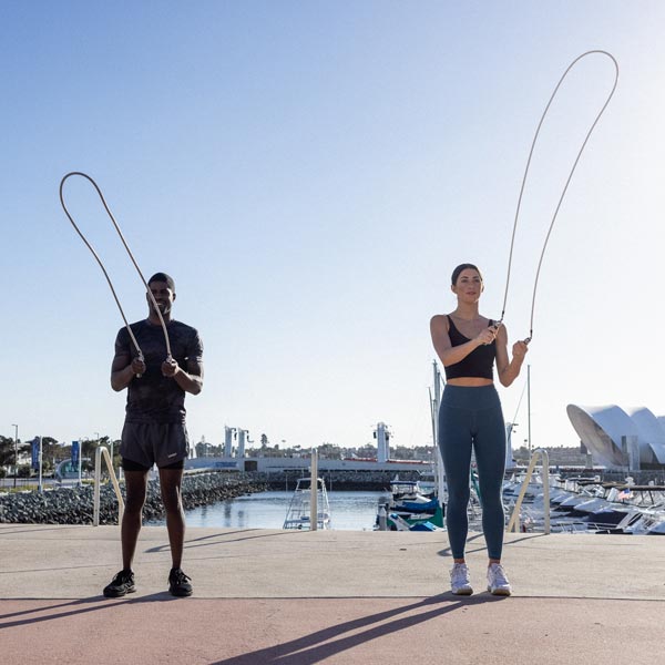 Two people outdoors, jump rope workouts with Crossrope