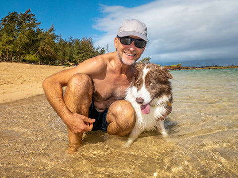 Dr. Peter Dobias and his dog Pax on a Maui beach together