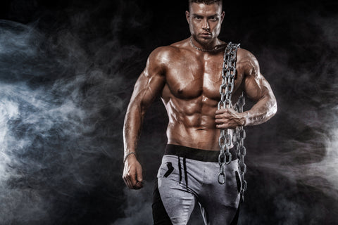 Shirtless man carrying a heavy chain
