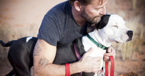 Man with dog wearing a collar