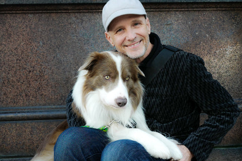 Dr. Peter Dobias with his dog Pax on his lap