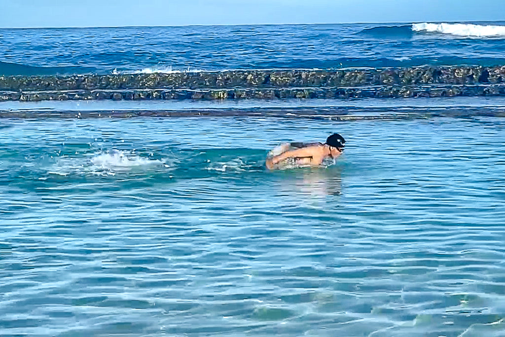 Dr. Dobias swimming the butterfly stroke in the ocean