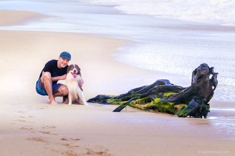 Dr. Peter Dobias with his dog Pax on the beach