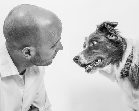 Dr. Dobias and his dog Skai looking at each other