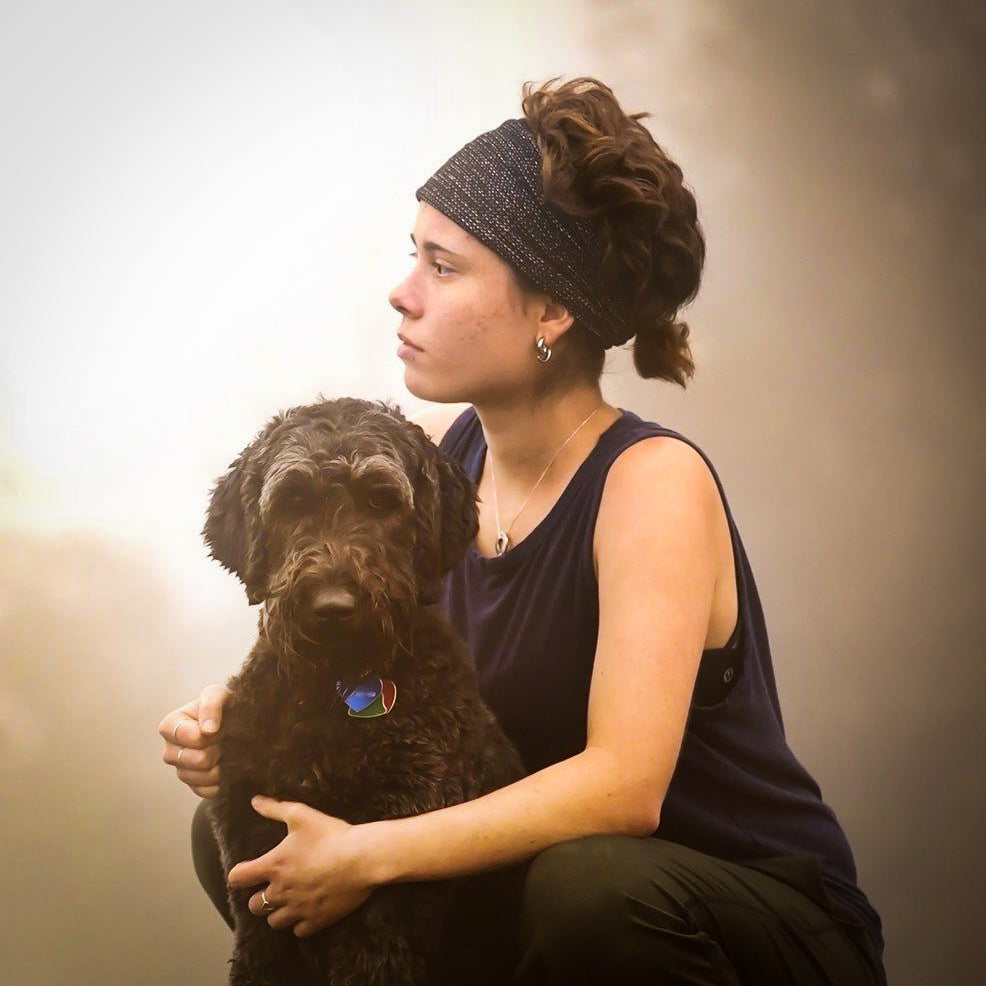 Woman holding dog looking into the distance