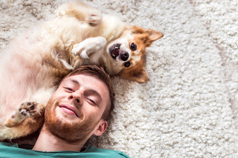 Man lying on floor with dog