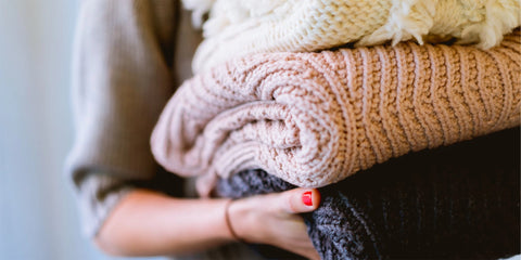 Woman Holding Wool Sweaters