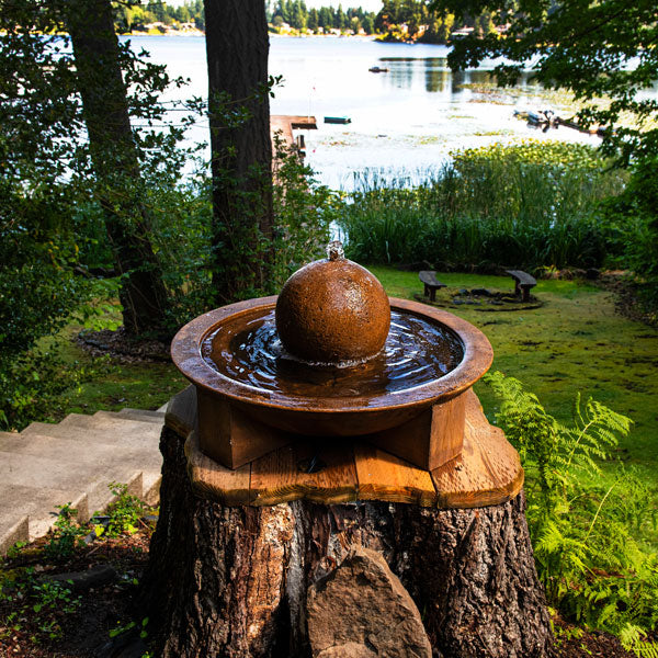 Low Zen sphere fountain beside concrete stairs near lake.jpg