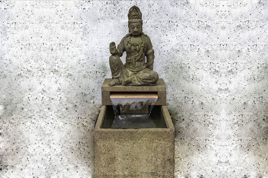 Antique Quan Yin Fountain in aged limestone against white backdrop