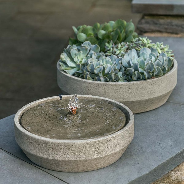 Campania International Beveled Yuma Fountain on ledge in the backyard