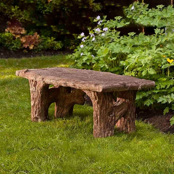 Campania International Faux Bois Bench on grass in the backyard