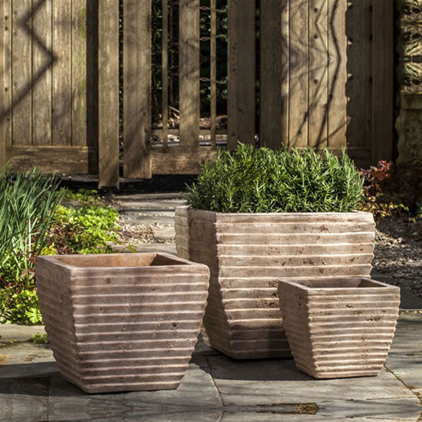 Campania International Ipanema Square Planter - Antico Terra Cotta S/3 filled with plants in the backyard