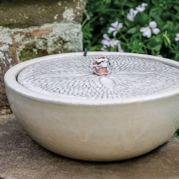 Campania International Sand Dollar Fountain in glazed cream in the backyard