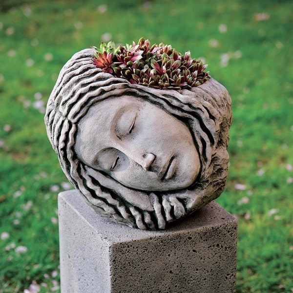 Campania International Sleeping Maiden Planter filled with plants in the backyard