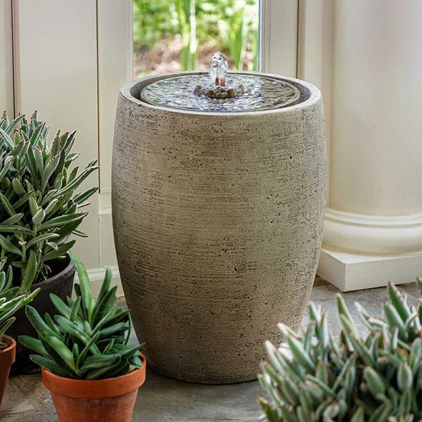 Campania International Soma Medallion Fountain on concrete beside cactus