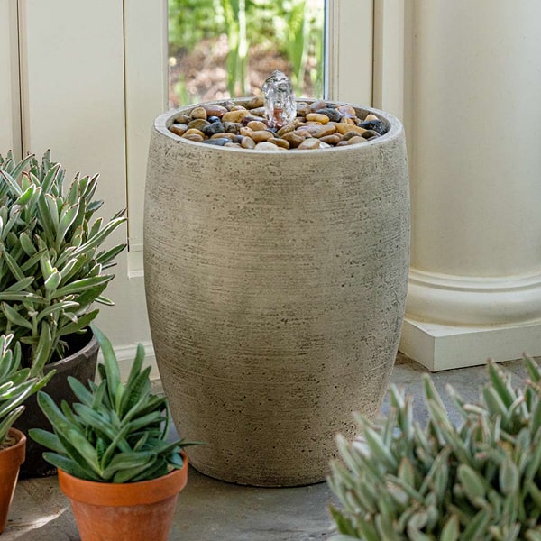 Campania International Soma Pebble Fountain on concrete beside cactus