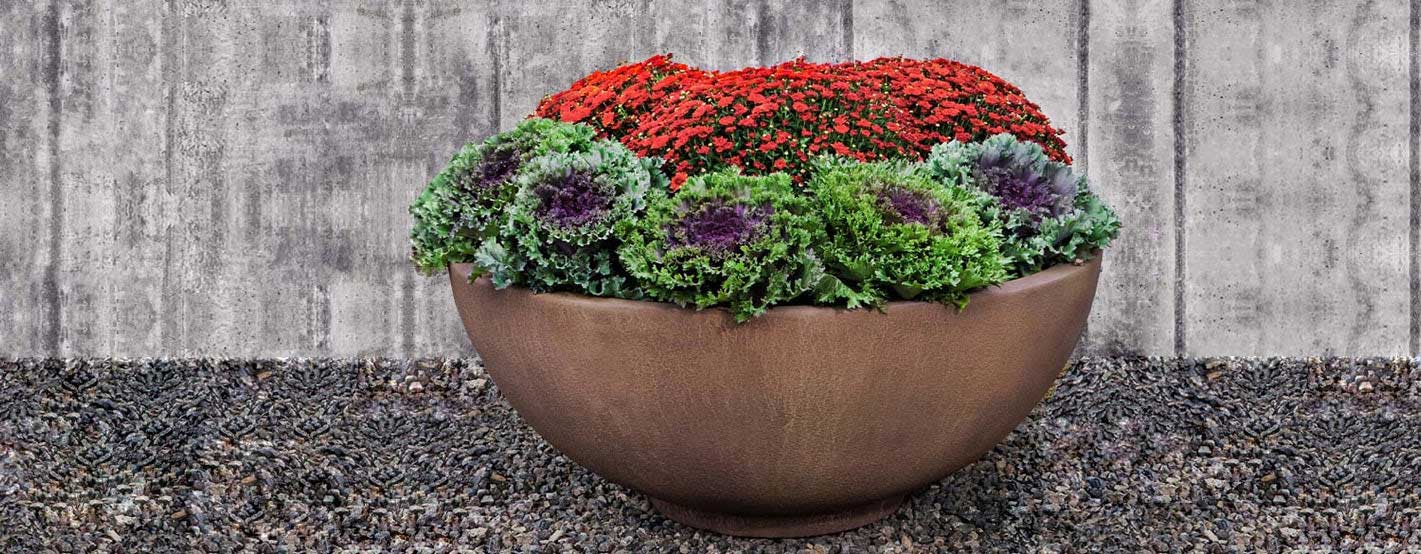 Contour Low Bowl 4719 on gravel filled with flowers