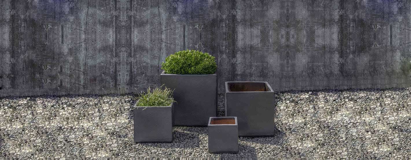 Hancock Planter - Metal Grey S/4 filled with plants against gray wall