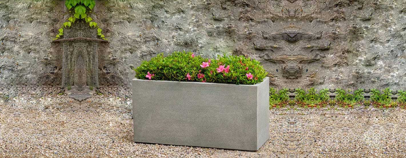 Metro Box Planter on gravel filled with pink flowers