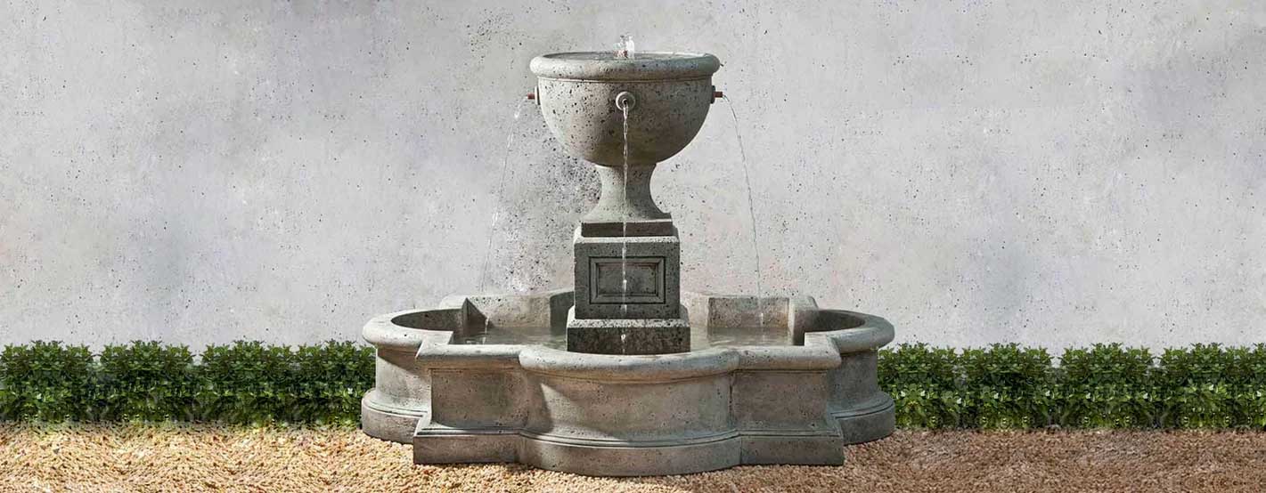 Navonna Fountain on gravel against gray wall