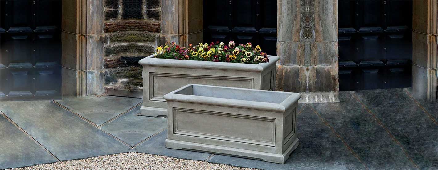 Orleans Window Box Planter, Large on concrete filled with flowers