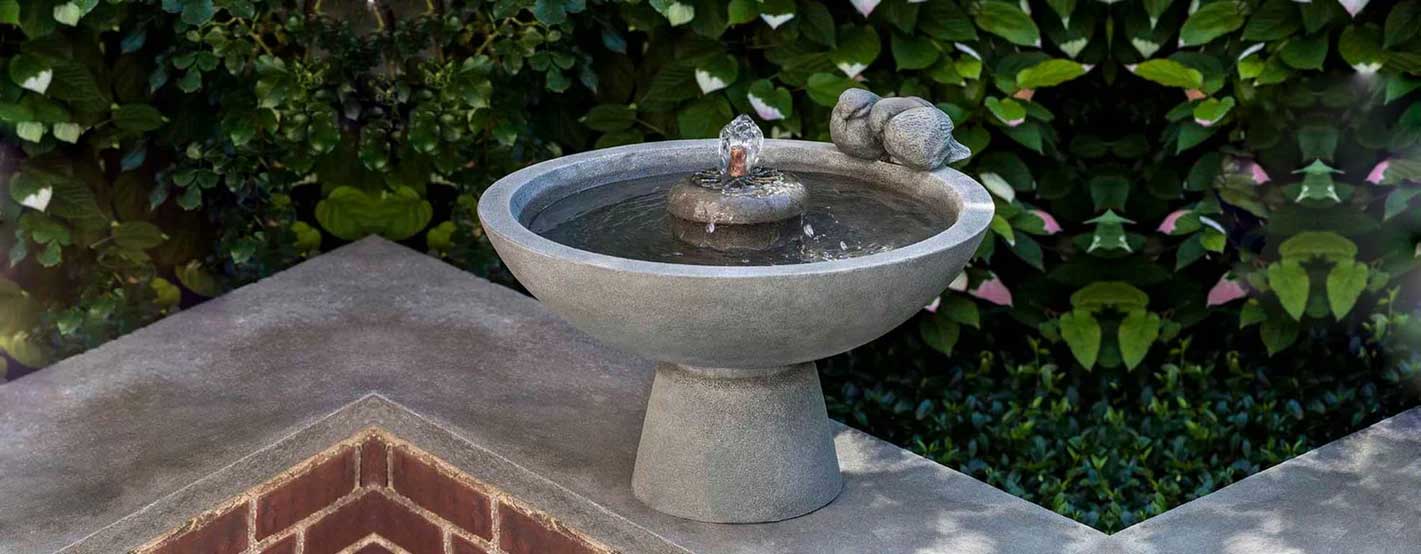 Paradiso Fountain on ledge against green leaves