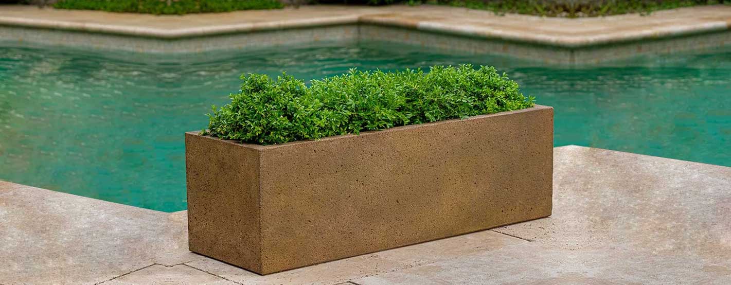 Rustic Trough Planter filled with plants beside swimming pool