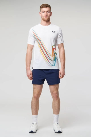 Man in white Castore running t shirt and navy shorts