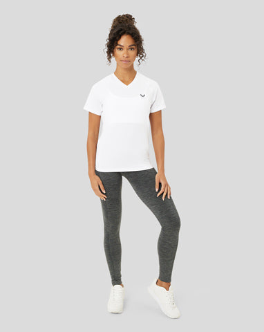 Woman in white t-shirt and grey leggings